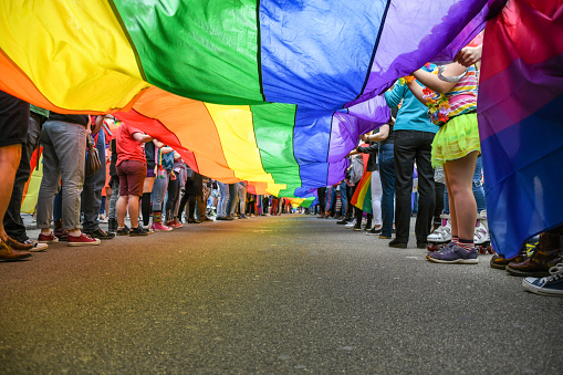 Under a LGBT Pride Flag, taken at Exeter Pride Parade, public event.