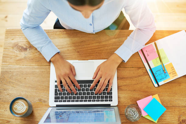 istock Top down view on hands of woman typing at computer 683557928