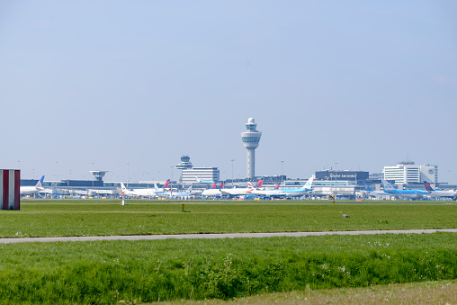 Parked airplanes at terminal Dock Midfield at Swiss Airport Zürich Kloten on a sunny spring day. Movie shot April 14th, 2023, Kloten, Canton Zurich, Switzerland.