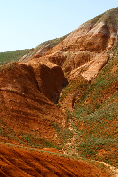 istock Layered eroded mountains with the green grassy slope 683568118