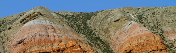 istock Rainbow colorful mountains with the green grassy slopes 683568418