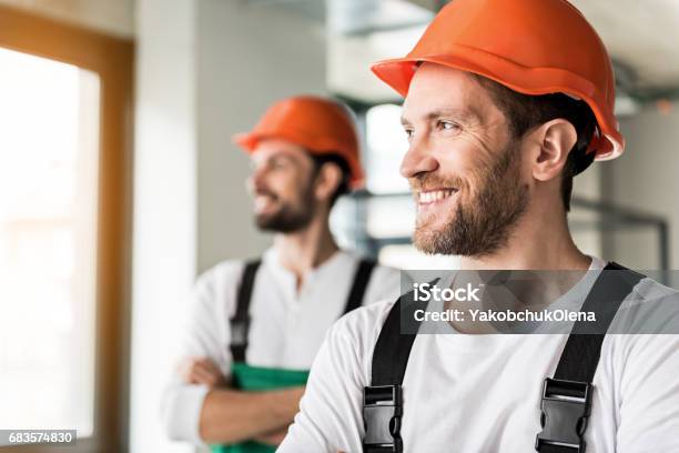 Hilarious Smiling Erectors In Room Stock Photo - Download Image Now - Repairperson - Occupation, Happiness, Construction Site