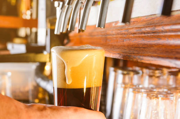 istock Barman is serving beer from faucet 683576104