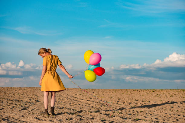 istock Young woman with toy balloons 683579848