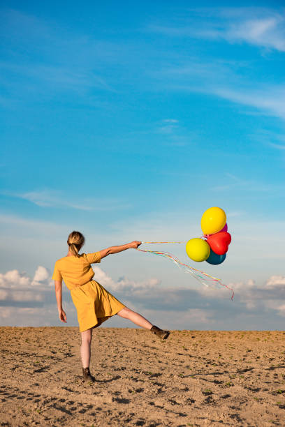 istock Young woman with toy balloons 683579960