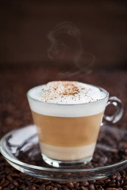 istock Cup of fresh hot latte on coffee bean background 683583844