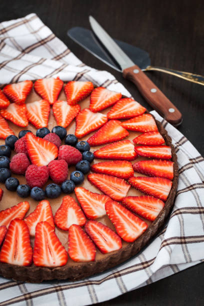istock Delicious chocolate tart decorated with fresh strawberry, blueberry and raspberry 683585504