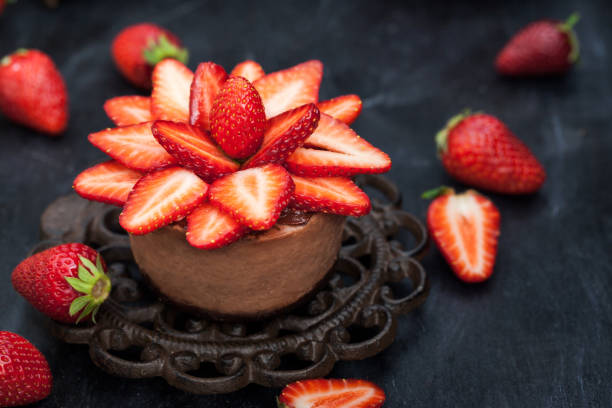 istock Mini chocolate cheesecake  dessert decorated with fresh strawberries 683586046