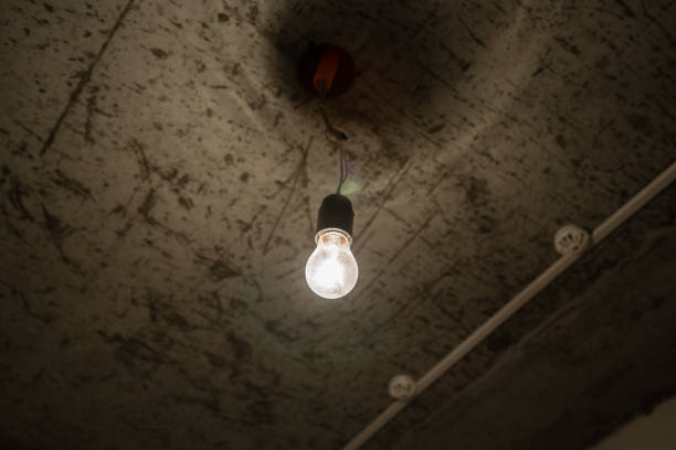 istock Light bulb close-up in a dark room. 683586886