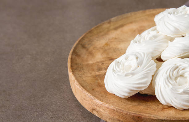 istock Meringue dessert Pavlova cake with fresh berries on a stone background 683587036