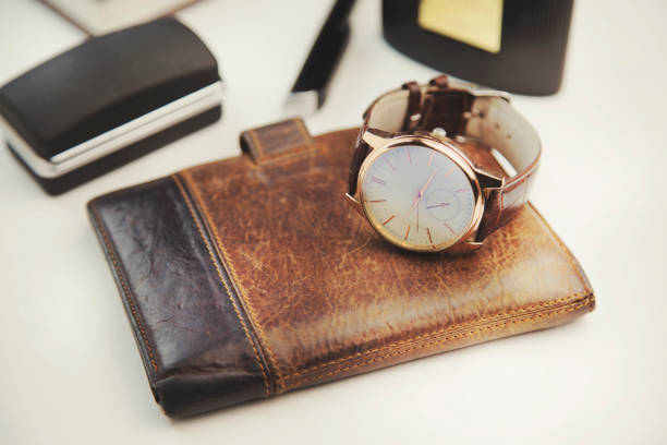 istock man watch on wallet on white background 683587524