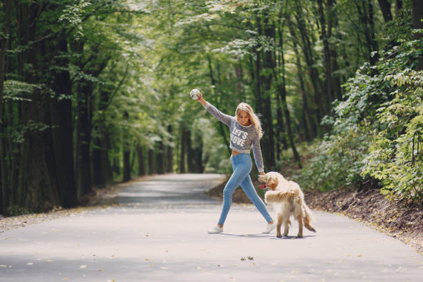 istock couple walking outdoors with her dog 683590212