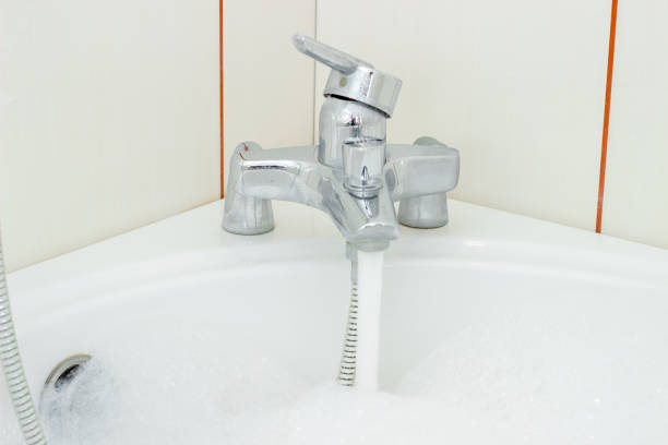 istock water flows into the bathroom from an open faucet 683591206
