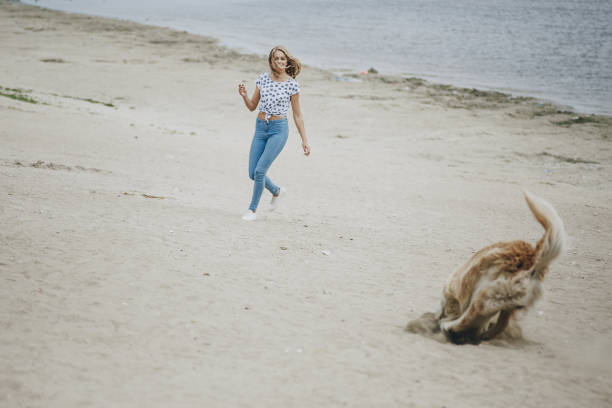 istock couple walking outdoors with her dog 683593570