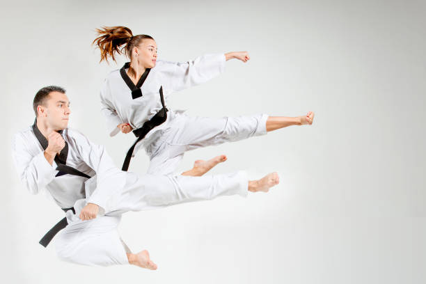 istock The karate girl and man with black belts 683600734
