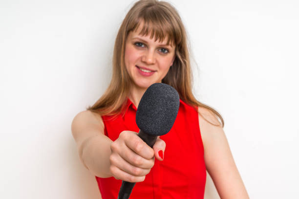 istock Female reporter at press conference with microphone 683601286
