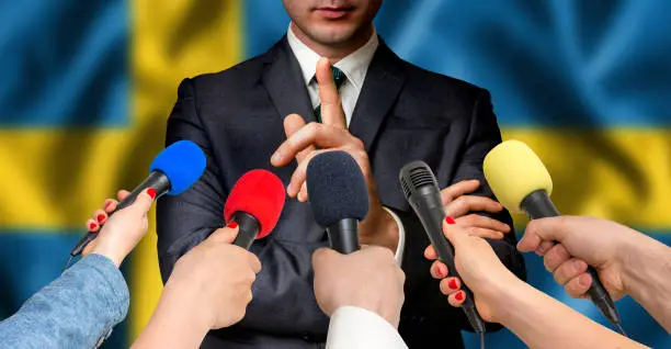 Photo of Swedish candidate speaks to reporters - journalism concept