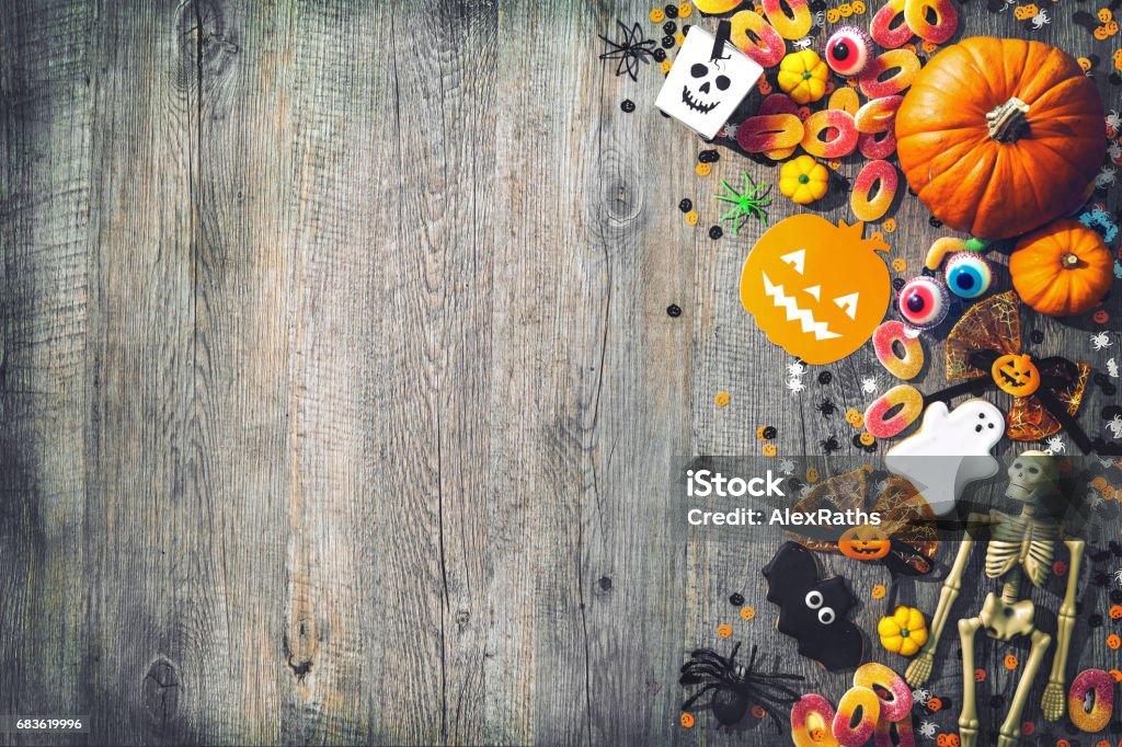 Halloween holiday background Halloween holiday background with skull, skeleton, spiders, pumpkins and candy. View from above Halloween Stock Photo