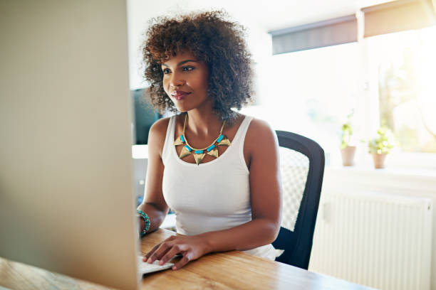 istock Young African American woman working at a computer 683620924