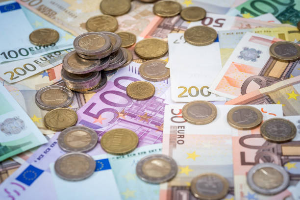 istock euro coin lying on banknotes close up 683621462