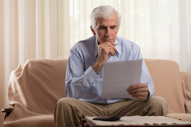 istock Older man doing his taxes 683624484