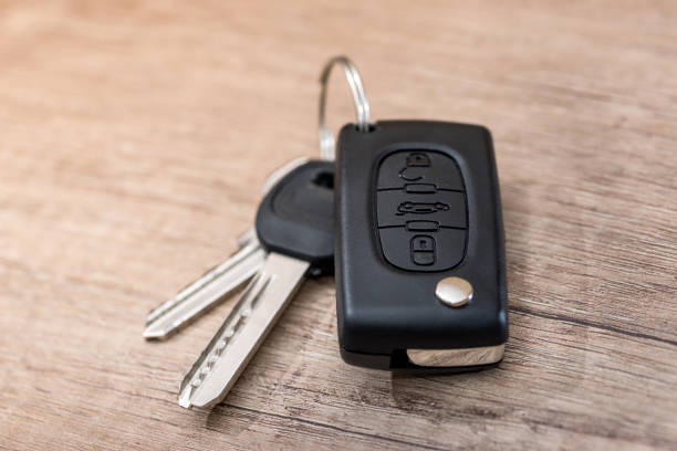 black car key on wooden desk with copy space. black car key on wooden desk with copy space. car keys table stock pictures, royalty-free photos & images
