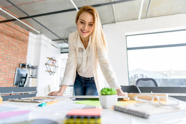 istock Successful girl leaning on her table with positive emotions 683628154