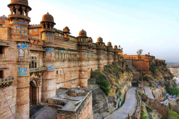GWALIOR FORT, MADHYA PRADESH, INDIA Gwalior Fort was built in the 15th century. This great Fort spreads out over an area of 3 square km and is built at a vantage height of 100 m above the city and the Fort is bounded by solid walls of sandstone, which encloses three temples, six palaces and a number of water tanks. raja stock pictures, royalty-free photos & images