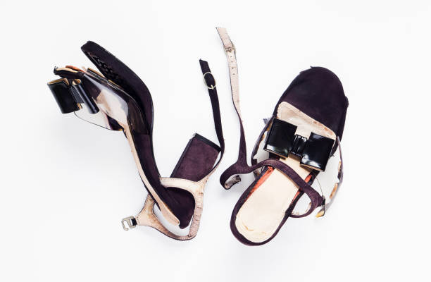 istock Female broken high heel shoes on white background 683652272