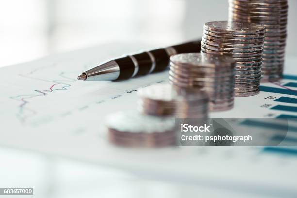 Stack Of Coins With Line Chart And Bar Graph Stock Photo - Download Image Now - Pension, Coin, Bar Graph