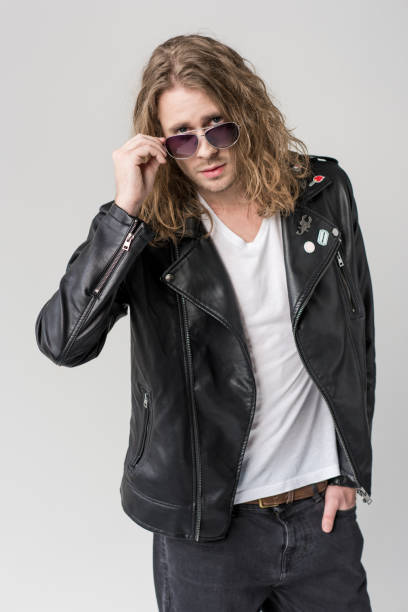 istock young handsome rocker posing in black leather jacket and sunglasses isolated on grey 683660202