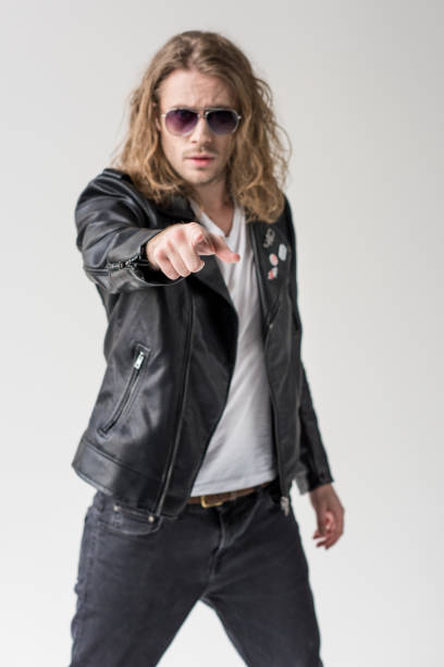 istock young handsome man in black leather jacket pointing isolated on grey 683660458