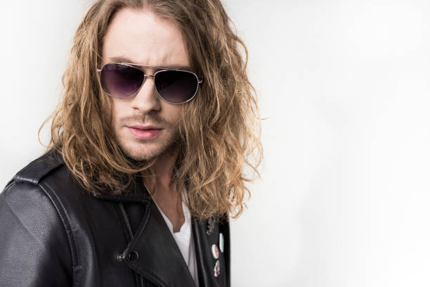 istock young handsome rocker in black leather jacket and sunglasses isolated on grey 683660640
