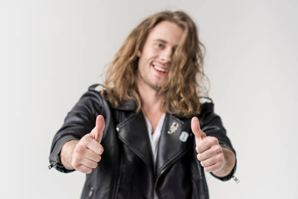 istock young handsome man in black leather jacket showing thumbs up isolated on grey 683664190