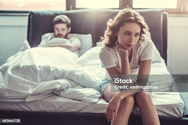 Couple In Bedroom Stock Photo - Download Image Now - Couple - Relationship, Frustration, Bed - Furniture