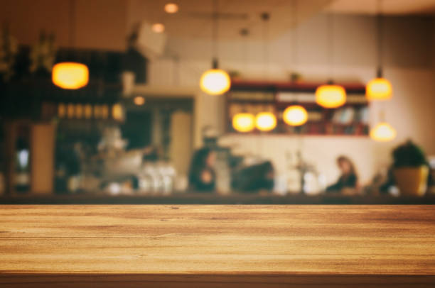 istock wooden table in front of abstract blurred restaurant lights background 683671634
