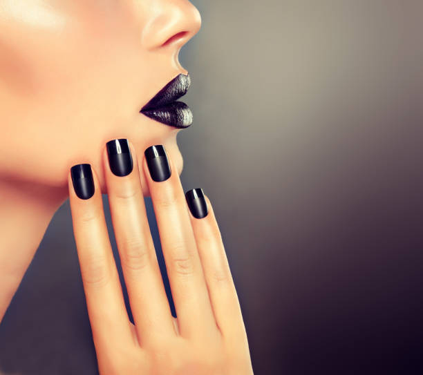 istock Manicure and make up in black color. 683674056