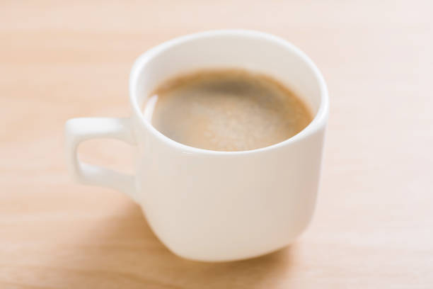 Cup of hot coffee on wooden background