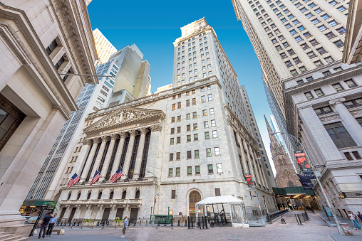 New York City, USA - June 25, 2016: Wall Street and New York Stock Exchange on a sunny day. The New York Stock Exchange on Wall Street - it is the largest stock exchange in the world.