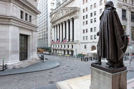 New York, USA - June 25, 2016: A view of Wall Street from the steps of the Federal Hall on a sunny day in New York, NY. The New York Stock Exchange in Wall Street the largest stock exchange in the world.