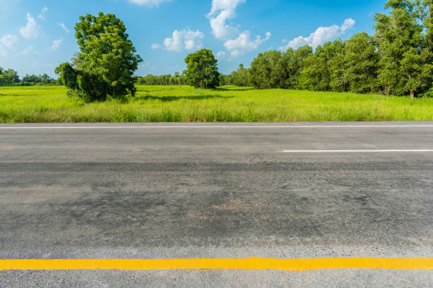 istock asphalt road and green rice field 683681382