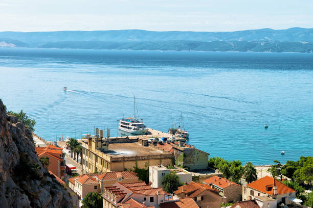 istock Panorama of Omis town between hills and Cetina River 683687386