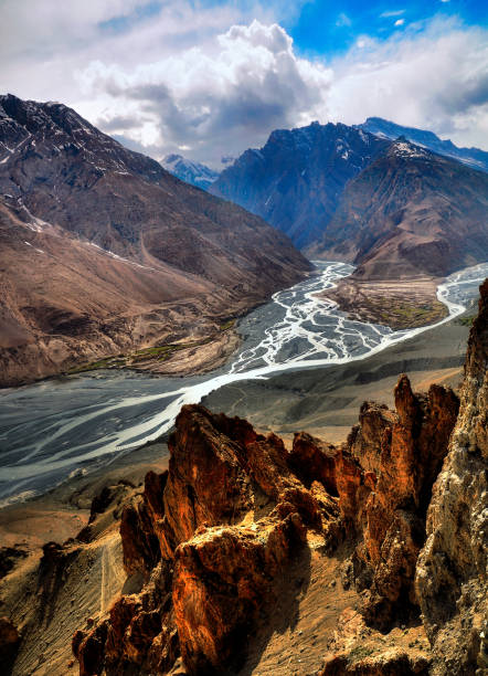Confluence of the Pin & Spiti rivers, beside Dhankar village, Spiti Valley, India. Vertical orientation, narrow angle of view. Confluence of the Pin (Left) & Spiti (Right) rivers, as seen from Dhankar Village, Himachal Pradesh, India. lahaul and spiti district photos stock pictures, royalty-free photos & images