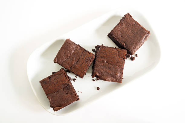 istock Sliced brownies on white plate. Served with chocolate fudge topping. On white plate with fork. 683716016