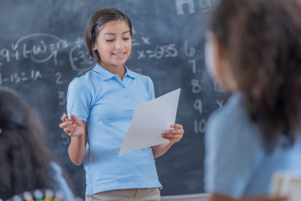 istock Confident student gives report in front of class 683722236