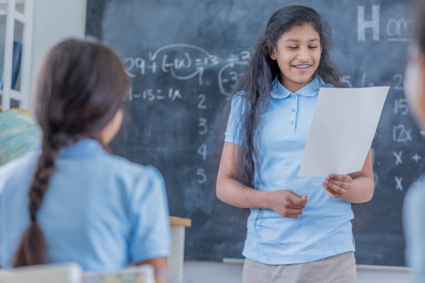 istock Confident Indian STEM students reads report to class 683722350