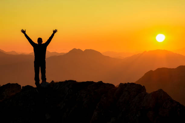 istock Happy success winning man arms up on mountain at sunset 683727902