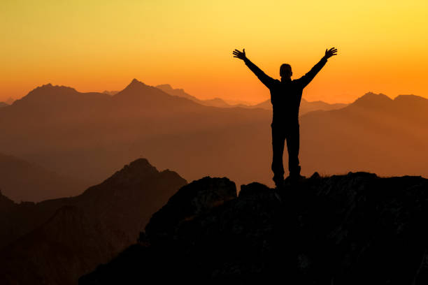 istock Happy success winning man on summit arms up at sunset 683728576