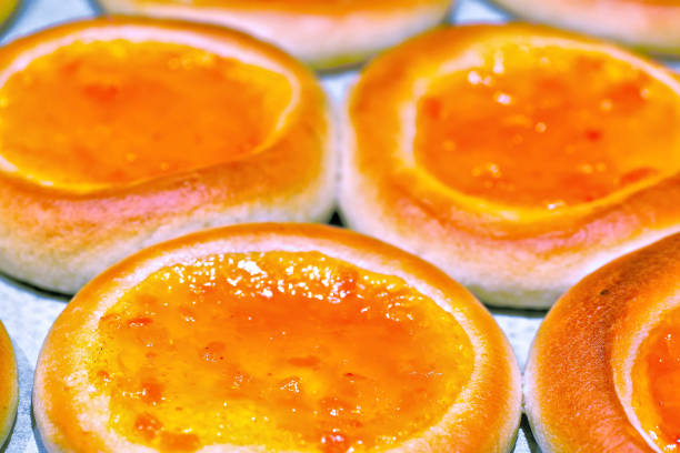 Round cake with orange jelly as a background. Shallow depth of field. Selectively tinted image.