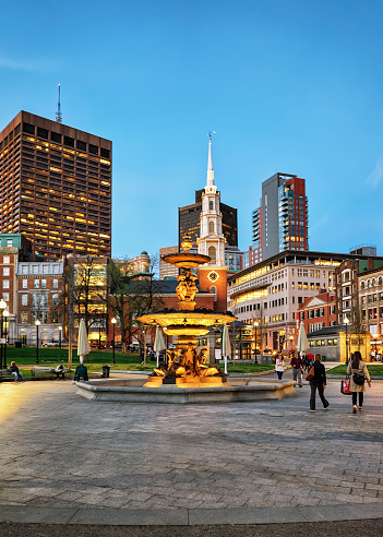 Boston, USA - April 28, 2015: Fountain at Boston Common public park and people in Boston, MA, United States. In the evening